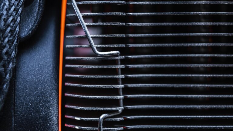 Radiador del coche: qué función tiene y cuánto cuesta cambiarlo 3 vista cercana de radadior de coche negro con un detalle rojo