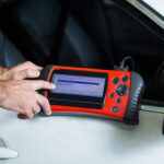 hands-mechanic-using-diagnostic-tool-1-150x150.jpg