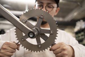 close up man repairing bike