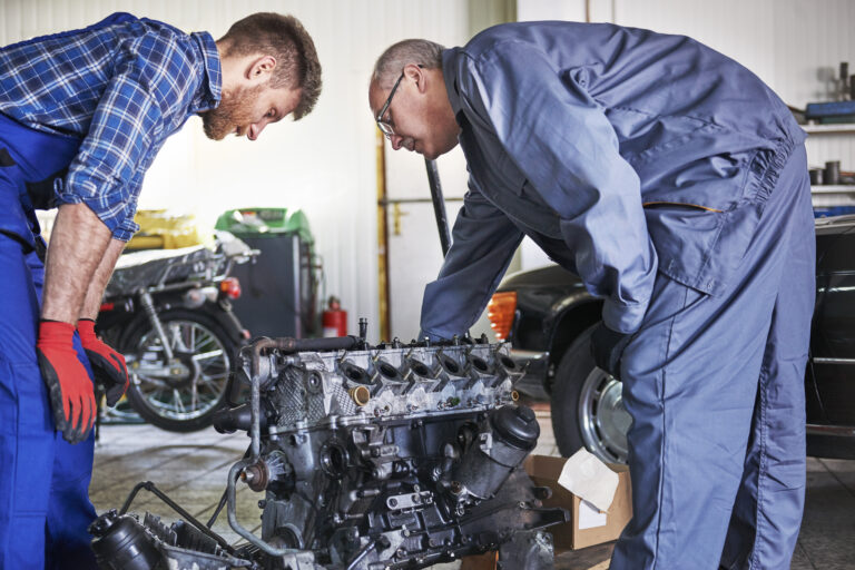 mechanics repairing car workshop