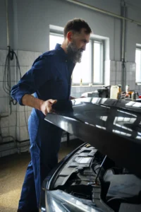 Cómo detectar problemas en el bastidor de tu vehículo 2 mecanico masculino que trabaja en un taller de reparacion de automoviles en un automovil