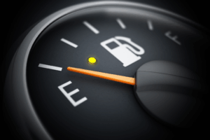 Mécanicien vérifiant le moteur d’une voiture pour optimiser la consommation de carburant.