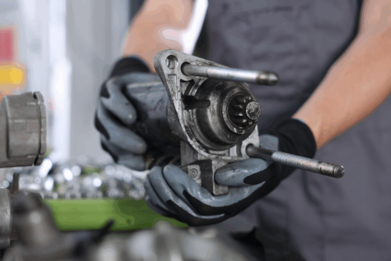 Motor de arranque: Principais avarias e guia de substituição passo a passo 8 Mecânico a substituir o motor de arranque de um automóvel numa oficina, ilustrando o processo de diagnóstico e montagem.